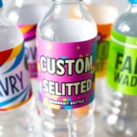 Custom water bottle labels being applied to bottles with colorful, waterproof designs for events and branding, showcasing durability and personalization.