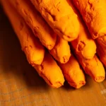 Turmeric Finger showcasing fresh bright orange color, high-quality and natural spice for